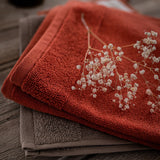 asciugamano con occhiello curl terracotta, colore terracotta, taglia 50 x 50. realizzato in 100% cotone, ideale per assorbenza e delicatezza sulla pelle