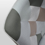 poltrona havana in tessuto multicolore e gambe in legno, dettaglio del rivestimento in tessuto o velluto