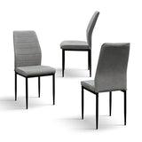 set di 4 sedie lubiana in tessuto grigio e gambe in metallo nero opaco, vista ambientata attorno a un tavolo da pranzo