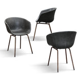 set di 4 sedie copenaghen rivestite in pelle antracite e gambe in metallo nero, vista ambientata attorno a un tavolo da...