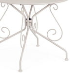 tavolo etienne in acciaio beige ø90 cm, ambientazione in giardino con sedie coordinate