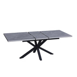 tavolo rettangolare allungabile rob con piano cemento e gambe in metallo nero, vista ambientata in spazi open space moderni