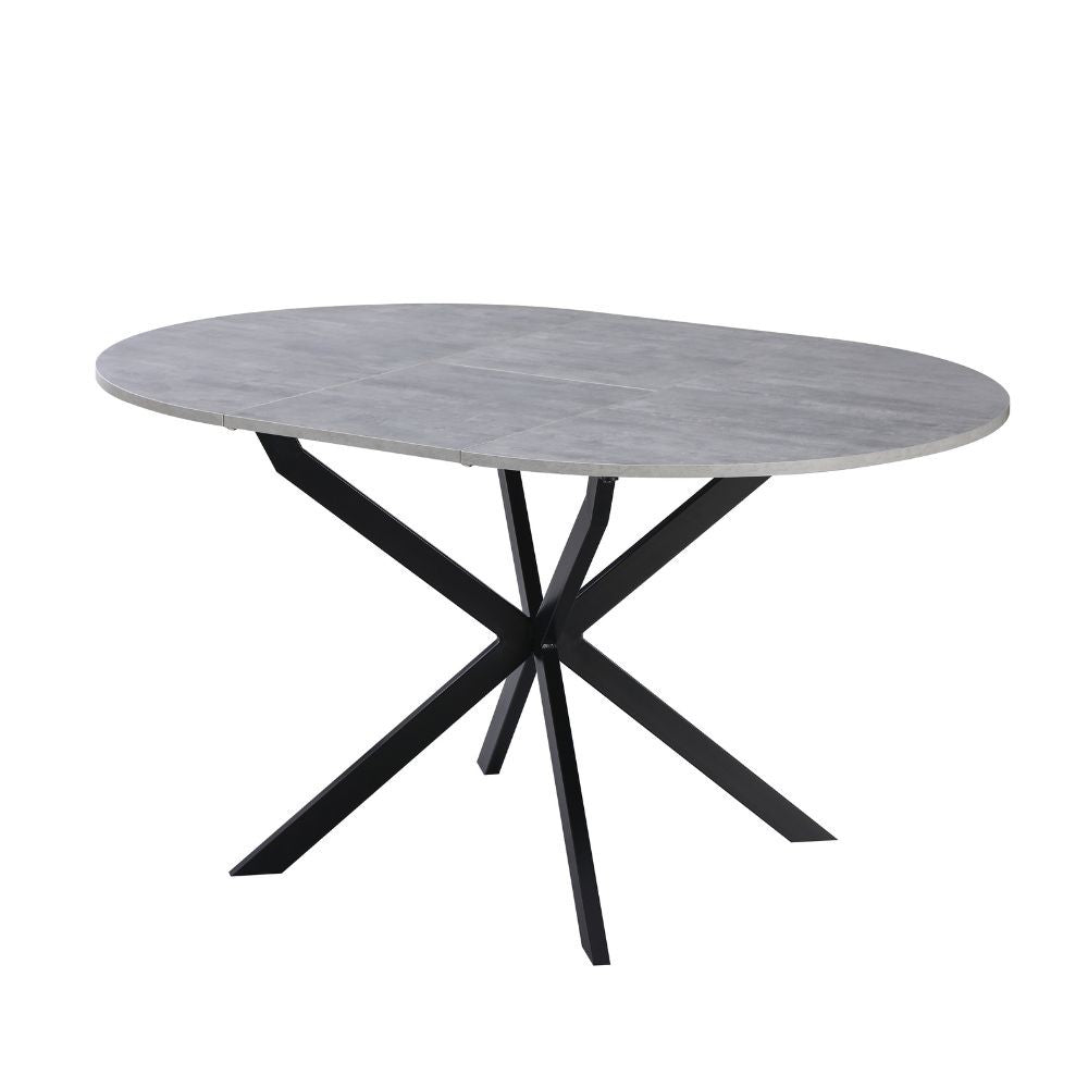 tavolo rotondo allungabile rut con piano colore cemento e gambe in metallo nero, vista ambientata in sala da pranzo elegante