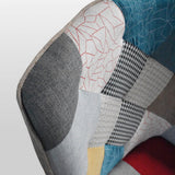 poltrona havana in tessuto patchwork multicolore e gambe in legno, dettaglio del rivestimento in tessuto o velluto