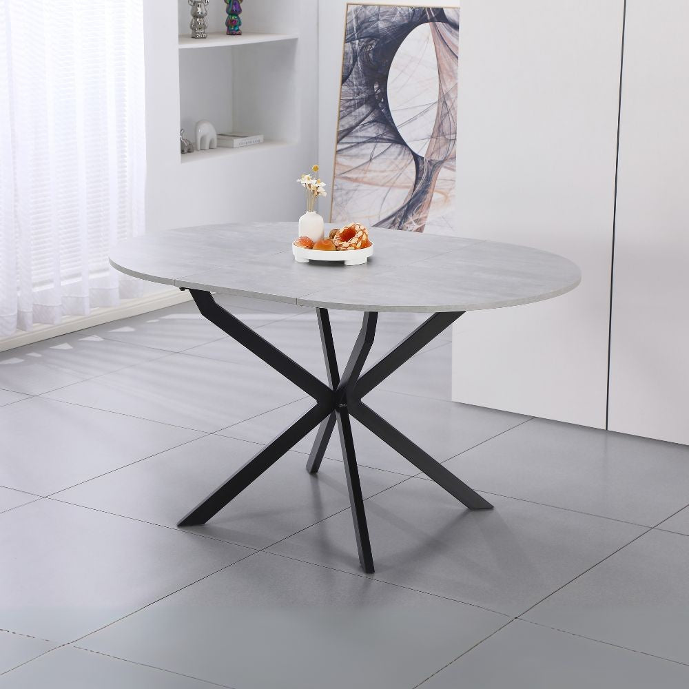 tavolo rotondo allungabile rut con piano colore cemento e gambe in metallo nero, tavolo rotondo ideale per conversazioni conviviali