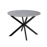 tavolo rotondo allungabile rut con piano colore cemento e gambe in metallo nero, dettaglio del piano circolare e supporto centrale