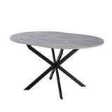 tavolo rotondo allungabile rut con piano colore cemento e gambe in metallo nero, vista ambientata in sala da pranzo elegante