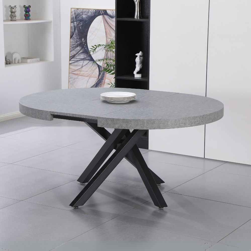 tavolo allungabile raven con piano colore cemento e gambe in metallo nero, tavolo rotondo ideale per conversazioni conviviali