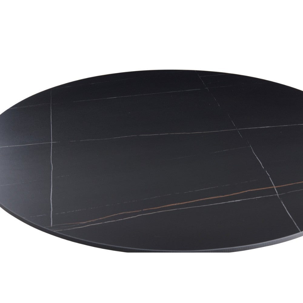 tavolo rotondo dot con piano in ceramica effetto marmo nero opaco con particolari oro e gamba nera, arredo raffinato per ambienti classici o moderni
