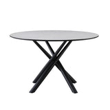 tavolo tondo logan con piano cemento e gambe in metallo nero φ120*76.5 cm., vista ambientata in sala da pranzo elegante